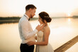 © omelnickiy - bride and groom against the backdrop of a yellow sunset