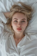 Poster - A person lying down with a white shirt on, possibly after waking up or getting dressed
