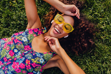 Wall Mural - young stylish black woman having fun in park summer fashion style