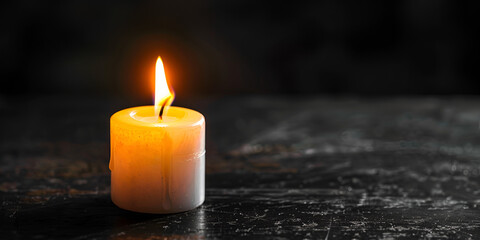 Wall Mural - A Burning Candle on black background