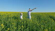 © artifex.orlova - Boy And Mother Playing In Canola Field In Summer. Little Cute Boy In A Rapeseed Field Flower. Child Plays In Rape Flower Field.