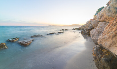 Wall Mural - Rocks in the water in Sardinia at sunset