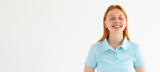 Wall Mural - Beautiful caucasian woman dreamy smiling with eyes closed, standing relaxed and happy against white background. Copy space