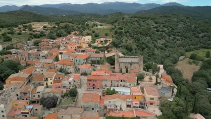 Wall Mural - Aerial drone images of Rabos, a small medieval town in the mountains of Catalonia in Spain, surrounded by green vineyards