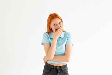 Wall Mural - Happy woman closing her mouth with hands going to see surprise prepared by husband standing and smiling in anticipation for something wonderful. Young cheerful lady covering face with hands