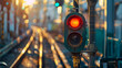 © JuroStock - A red traffic light is lit up in the foreground of a train track