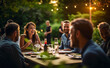 © Viks_jin - Group of Friends Enjoying a Garden Dinner Party in a Backyard Setting with String Lights. Friendship and Socializing Concept.