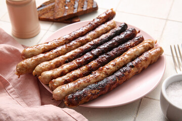 Wall Mural - Plate of tasty grilled sausages on white tile background