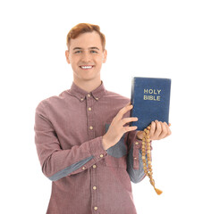 Wall Mural - Young redhead man with Bible and rosary beads isolated on white background