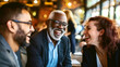 © OMD - Joyful gathering of three adults laughing together in a cozy restaurant setting