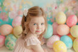 © Steven - A young girl with a gentle smile sits among pastel Easter eggs, radiating innocence and the joy of spring