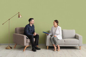 Wall Mural - Human resources manager interviewing applicant near green wall in office