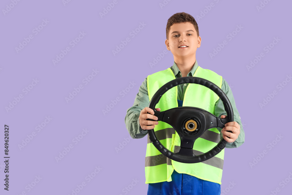Teenage worker with car steering wheel on lilac background