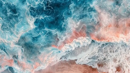 An overhead view of ocean waves mixing with sand to create an abstract and painterly landscape in shades of blue and pink.
