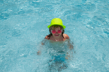 Poster - Funny kids face. Child splashing in swimming pool. Swim water sport activity on summer vacation with child.