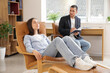 © Pixel-Shot - Young woman lying on armchair during hypnosis session at psychologist office