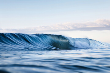 Wall Mural - A solitary wave in a calm sea under a clear sky.
