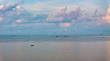 Wall Mural - windmill park with clouds and a blue sky, wind mill turbines in the ocean aerial view of a wind farm