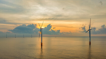 Wall Mural - windmill park with clouds and a blue sky, wind mill turbines in the ocean aerial view of a wind farm