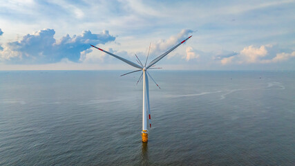 Wall Mural - windmill park with clouds and a blue sky, wind mill turbines in the ocean aerial view of a wind farm