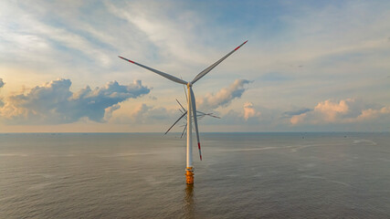 Wall Mural - windmill park with clouds and a blue sky, wind mill turbines in the ocean aerial view of a wind farm