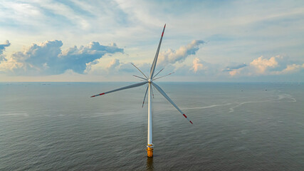 Wall Mural - Windmill park with clouds and a blue sky, wind mill turbines in the ocean aerial view of a wind farm in the Ba Dong beach, Tra Vinh, Vietnam production clean energy