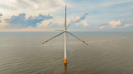 Wall Mural - windmill park with clouds and a blue sky, wind mill turbines in the ocean aerial view of a wind farm