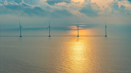 panoramic view of wind farm or wind park, with high wind turbines for generation electricity with co