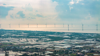 Wall Mural - windmill park with clouds and a blue sky, wind mill turbines in the ocean aerial view of a wind farm