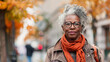 © Agata25 - Mature Black Woman Standing on Autumn Street with Orange Scarf