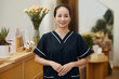 © DragonImages - Portrait of smiling spa salon beautician in black uniform