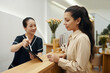 © DragonImages - Spa salon receptionist answering phone call from client