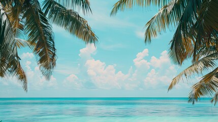 A beautiful blue ocean with palm trees in the background. The sky is clear and the sun is shining