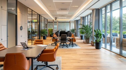 A large open office space with a lot of plants and a few chairs. The room is well lit and has a modern feel