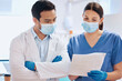 © peopleimages.com - Paper, dentist team and reading in clinic for orthodontics, collaboration and support. People, medical report and together for dental care or oral hygiene, healthcare and talking on surgery