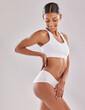 © peopleimages.com - Woman, body and underwear for skincare in studio for beauty, healthy or hair removal with slim waist for wellness. Happy, female person and cosmetics, natural and shine for health on white background