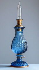 Wall Mural - A vintage oil lamp with a blue glass base and a tall, clear chimney, beautifully polished and ready to use.