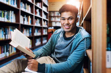 Poster - Student, man and portrait with writing in library for studying, scholarship and reading a book for exam information. Education, person or happy with notebook for research notes and knowledge on floor