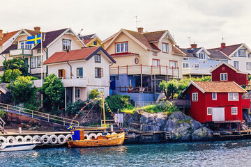 Poster - Fishing boat at a jetty by a swedish fishing village in the summer