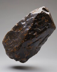 A large black rock with a shiny surface