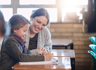 Poster - Happy teacher, learning and help kid writing in notebook for education, studying and knowledge in class. Woman, educator and girl student in lesson for development or assistance at elementary school