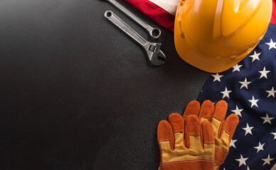 Wall Mural - Happy Labor day concept. American flag with different construction tools on dark background.