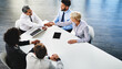 © peopleimages.com - Company, meeting and agreement for people, handshake and research for startup, online and top view of team. Collaboration, laptop and internet for news in boardroom, budget analyst and app for plan