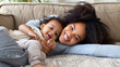 © Anton - happy black mother playing with daughter lying on sofa - delightful mom relaxing with baby indoors - family and childhood life style concept isolated on white background, png