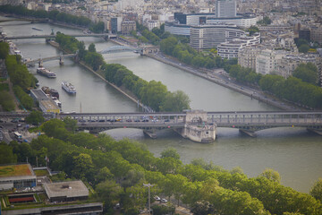 Wall Mural - Aerial scenic view of the river Seine with Bir-Hakeim bridge with subway trains on it and touristic boats in Paris, France.