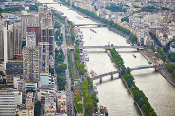 Wall Mural - Aerial scenic view of the river Seine with Bir-Hakeim bridge with subway trains on it and touristic boats in Paris, France.