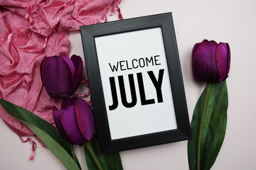 Wall Mural - welcome july text message with tulip flower on pink background