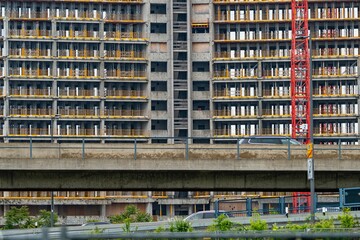 Wall Mural - A detailed view of a high-rise building under construction with scaffolding and a crane