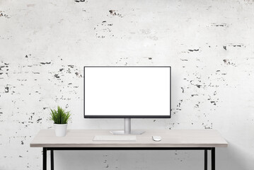 Aufkleber - Computer display mockup on a clean work desk with a rough wall background. Ideal for showcasing digital designs in a minimalist and textured office environment