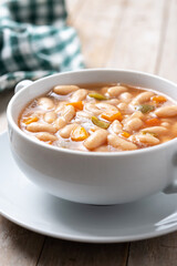 Wall Mural - White beans soup with vegetables in white bowl on wooden table